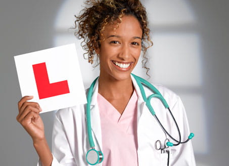 Image of doctor holding L plate. Credit: Getty Images